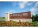 Community sign for 'The Oaks at Kelly Park by Toll Brothers' with colorful flower bed at 2583 Long Pine Ave, Apopka, FL 32712