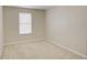 Well-lit bedroom with neutral carpet and walls, complemented by a window at 2901 Ashford Park Pl, Oviedo, FL 32765
