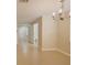 Dining area featuring tile flooring, a modern chandelier, and a powder room entrance at 2901 Ashford Park Pl, Oviedo, FL 32765