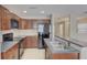 Modern kitchen with stainless steel appliances, dark cabinets, and breakfast bar at 2901 Ashford Park Pl, Oviedo, FL 32765
