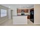 Bright kitchen featuring dark cabinetry, an island with sink, and pantry storage at 2901 Ashford Park Pl, Oviedo, FL 32765