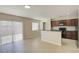 A kitchen with wood cabinets and black appliances opens to the living area and sliding glass door at 2901 Ashford Park Pl, Oviedo, FL 32765