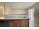A kitchen sink features stainless steel basin with dark wood cabinetry at 2901 Ashford Park Pl, Oviedo, FL 32765