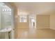 Open-concept living space featuring tile floors and a view of a dining area with chandelier at 2901 Ashford Park Pl, Oviedo, FL 32765