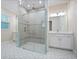 Elegant bathroom featuring glass shower, double sinks, and chandelier lighting at 2922 Reef Knot Pl, Winter Park, FL 32792