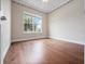 The bedroom features hardwood floors, a large window, and neutral-toned walls at 2922 Reef Knot Pl, Winter Park, FL 32792