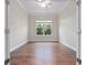 Vacant bedroom features hardwood floors, crown molding, a ceiling fan, and large window for natural light at 2922 Reef Knot Pl, Winter Park, FL 32792