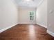 Spacious vacant bedroom features hardwood floors, a ceiling fan, and large window providing natural light at 2922 Reef Knot Pl, Winter Park, FL 32792