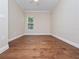 Bright, empty bedroom with hardwood floors, a ceiling fan, and large window providing ample natural light at 2922 Reef Knot Pl, Winter Park, FL 32792