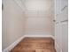Walk-in closet with hardwood floors and shelving at 2922 Reef Knot Pl, Winter Park, FL 32792