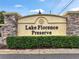 Elegant stone sign marking the entrance to Lake Florence Preserve with lush landscaping at 2922 Reef Knot Pl, Winter Park, FL 32792
