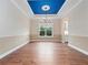 Open dining room featuring a dark blue tray ceiling and hardwood flooring at 2922 Reef Knot Pl, Winter Park, FL 32792
