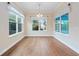 Bright dining room featuring hardwood floors, large windows and decorative valances at 2922 Reef Knot Pl, Winter Park, FL 32792