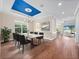 Elegant dining room featuring a bold blue ceiling and an open view to the living room and kitchen at 2922 Reef Knot Pl, Winter Park, FL 32792
