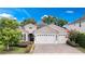 Charming home with a manicured lawn, brick driveway, and a three-car garage perfect for a Gathering at 2922 Reef Knot Pl, Winter Park, FL 32792