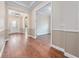 Hallway featuring hardwood floors, crown molding, and wainscoting, leading to the front entrance at 2922 Reef Knot Pl, Winter Park, FL 32792