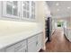 Close up of a well-appointed kitchen with stainless steel appliances, white cabinets, and a sleek countertop at 2922 Reef Knot Pl, Winter Park, FL 32792