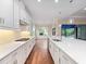 Well-lit kitchen with white cabinets, stone countertops, and modern appliances, with views to the backyard at 2922 Reef Knot Pl, Winter Park, FL 32792