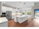 Bright kitchen with stainless appliances, large island, hardwood floors, and sliding doors to the outdoor patio at 2922 Reef Knot Pl, Winter Park, FL 32792
