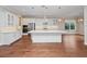 Expansive white kitchen with stainless steel appliances, sleek island, and hardwood flooring at 2922 Reef Knot Pl, Winter Park, FL 32792