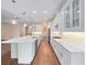 A modern, spacious kitchen with white cabinets, stainless steel appliances, and a large center island with pendant lighting at 2922 Reef Knot Pl, Winter Park, FL 32792