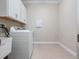 The laundry room features a utility sink, washer, dryer, and storage cabinets at 2922 Reef Knot Pl, Winter Park, FL 32792