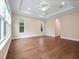 Spacious living room featuring hardwood floors, tray ceiling with ceiling fan, and natural light at 2922 Reef Knot Pl, Winter Park, FL 32792