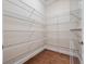 Walk-in pantry with hardwood floors and extensive metal shelving providing ample storage space at 2922 Reef Knot Pl, Winter Park, FL 32792