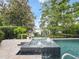 The swimming pool features a spa, travertine pavers, and lake views at 2922 Reef Knot Pl, Winter Park, FL 32792