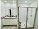 Bathroom featuring a double vanity, shower with glass door, and neutral tile floor at 29783 Anahid Dr, Leesburg, FL 34748