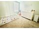 Bright Bedroom featuring a white dresser with gold knobs and a toddler bed with playful animal print bedding at 29783 Anahid Dr, Leesburg, FL 34748