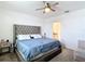Bedroom with king size bed, carpeted floor, ceiling fan and view of the en suite bathroom at 29783 Anahid Dr, Leesburg, FL 34748