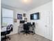 Bedroom with a large window, desk, and mounted television, perfect for a home office or study at 29783 Anahid Dr, Leesburg, FL 34748