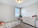 Bedroom with toddler bed, dresser, and window with natural light at 29783 Anahid Dr, Leesburg, FL 34748