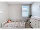 Bedroom featuring a toddler bed, dresser, and window with natural light at 29783 Anahid Dr, Leesburg, FL 34748