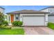 Charming single-story home with a two-car garage and well-maintained landscaping at 29783 Anahid Dr, Leesburg, FL 34748