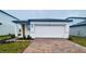 Charming single-story home featuring a two-car garage and a well-maintained brick driveway at 29783 Anahid Dr, Leesburg, FL 34748