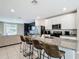 Open concept kitchen with stainless steel appliances, granite countertops, and adjacent living area at 29783 Anahid Dr, Leesburg, FL 34748