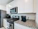 Kitchen with white cabinets, stainless steel appliances, and granite countertops at 29783 Anahid Dr, Leesburg, FL 34748