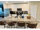 Modern kitchen featuring a large granite island with seating and stainless steel appliances at 29783 Anahid Dr, Leesburg, FL 34748