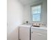 Well lit laundry room with washer and dryer at 29783 Anahid Dr, Leesburg, FL 34748