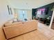 Comfortable living room featuring an oversized sectional sofa and a modern entertainment center at 29783 Anahid Dr, Leesburg, FL 34748