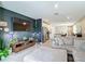 Living room featuring a modern television and decor, with an open floor plan to the kitchen and breakfast bar at 29783 Anahid Dr, Leesburg, FL 34748