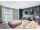 Cozy living room with a large screen television and sliding glass doors leading to outdoor space at 29783 Anahid Dr, Leesburg, FL 34748