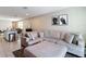 Comfortable living room with a large sectional sofa and connecting open floorplan to the kitchen and breakfast bar at 29783 Anahid Dr, Leesburg, FL 34748