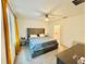 Spacious main bedroom featuring a ceiling fan, and a view into the en-suite bathroom at 29783 Anahid Dr, Leesburg, FL 34748