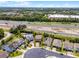 This aerial view highlights a charming home near a highway, pool, and solar panels, showcasing a well-located property at 3172 Jade Tree Pt, Oviedo, FL 32765