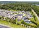 Aerial view of homes featuring a community pool and solar panels, all with well-manicured lawns at 3172 Jade Tree Pt, Oviedo, FL 32765