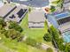 An aerial view of the property showcasing its backyard, covered patio, and proximity to lush landscaping and other residences at 3172 Jade Tree Pt, Oviedo, FL 32765