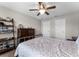 Comfortable bedroom with a ceiling fan and stylish ladder shelf for decor and storage at 3172 Jade Tree Pt, Oviedo, FL 32765